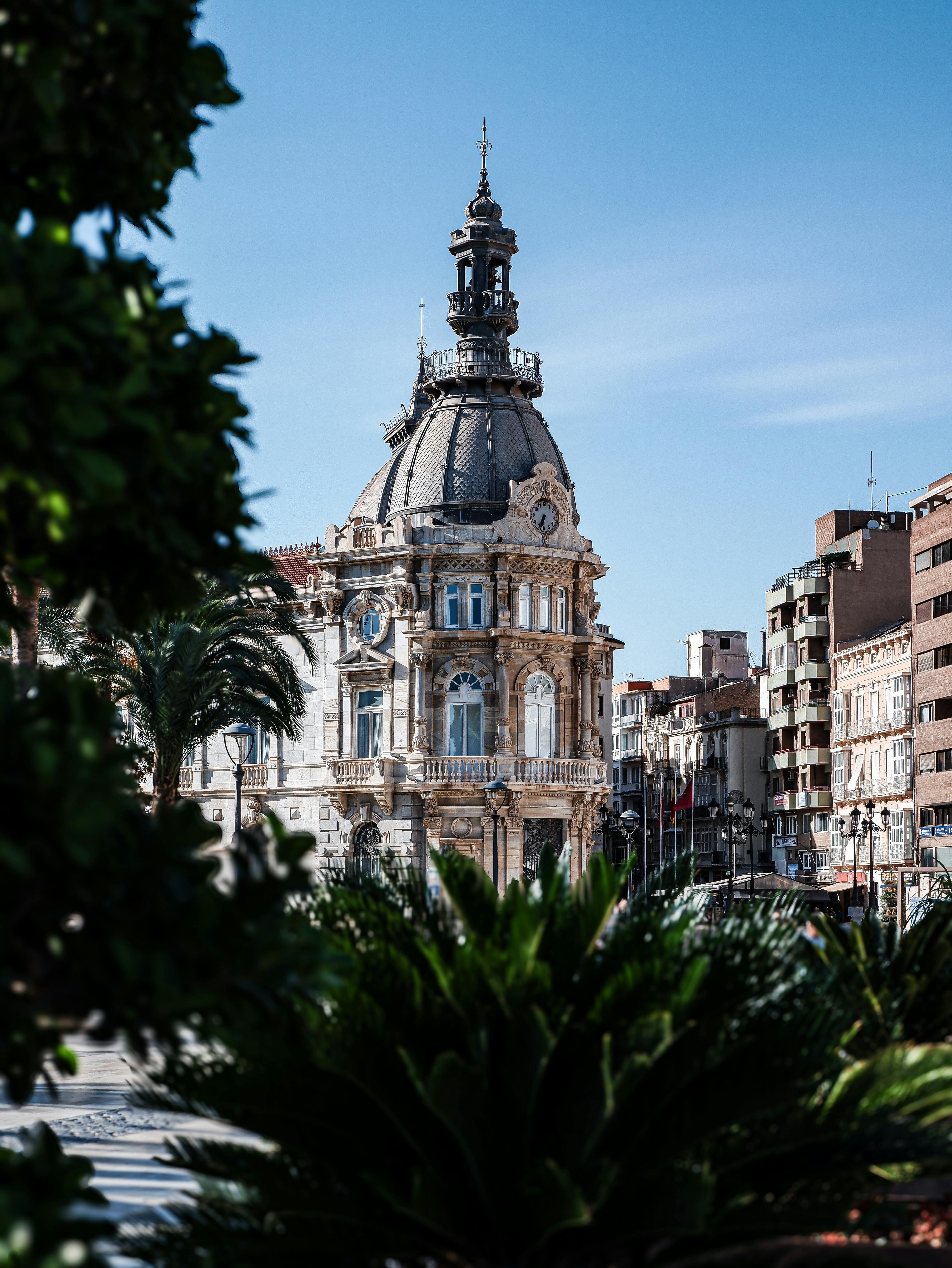 Historic architecture framed by greenery in Cartagena, one of the easiest day trips from Murcia.